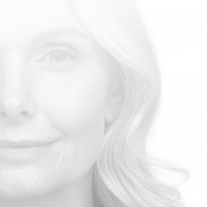 Faded back black and white closeup of the side of a woman's face