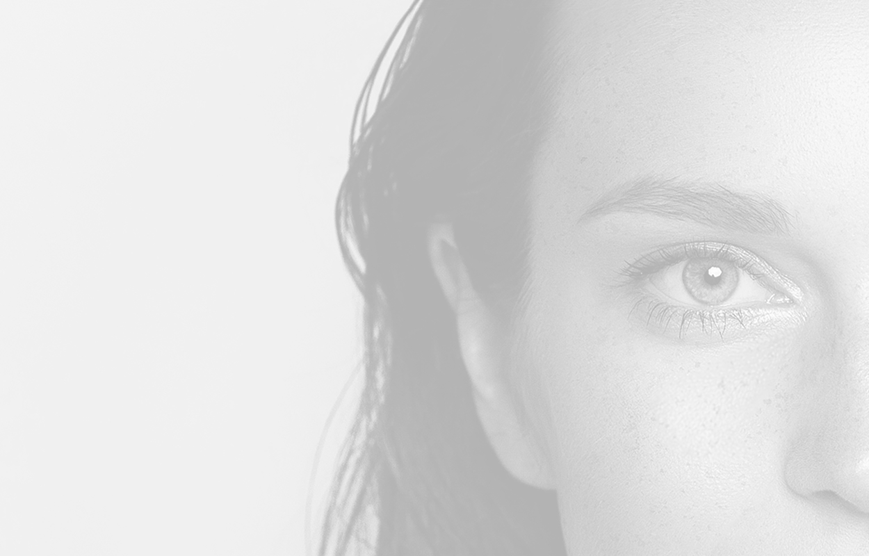 Faded back black and white closeup of the side of a woman's face